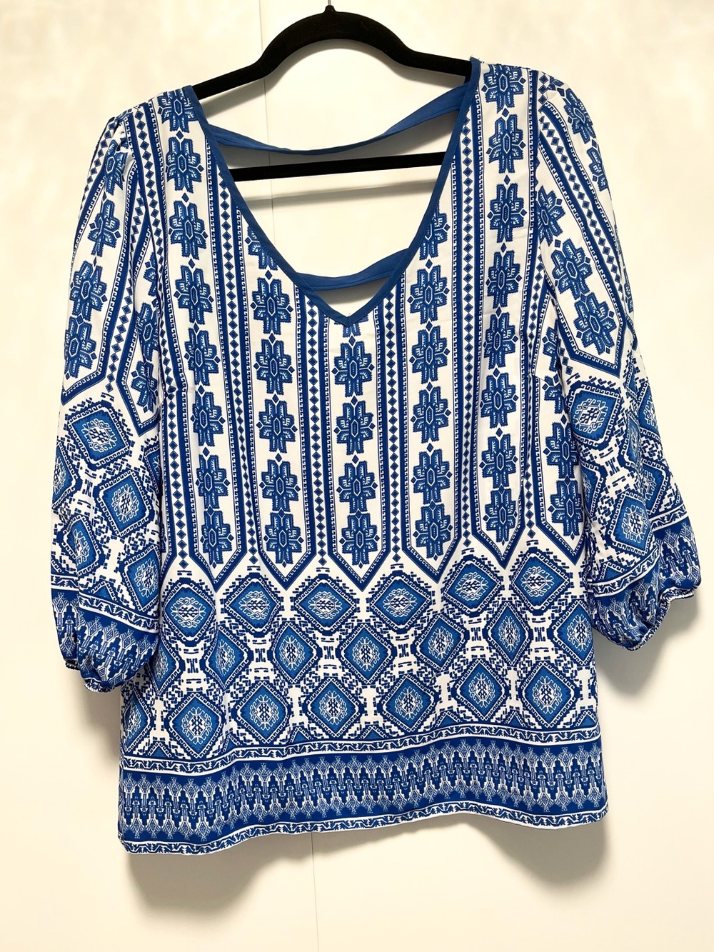 Royal blue and white patterned blouse